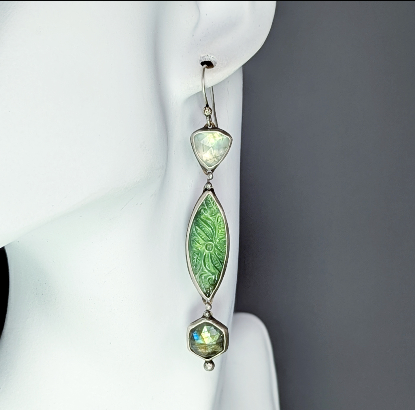 Carved serpentine, labradorite, and prehnite artisan statement earrings.
