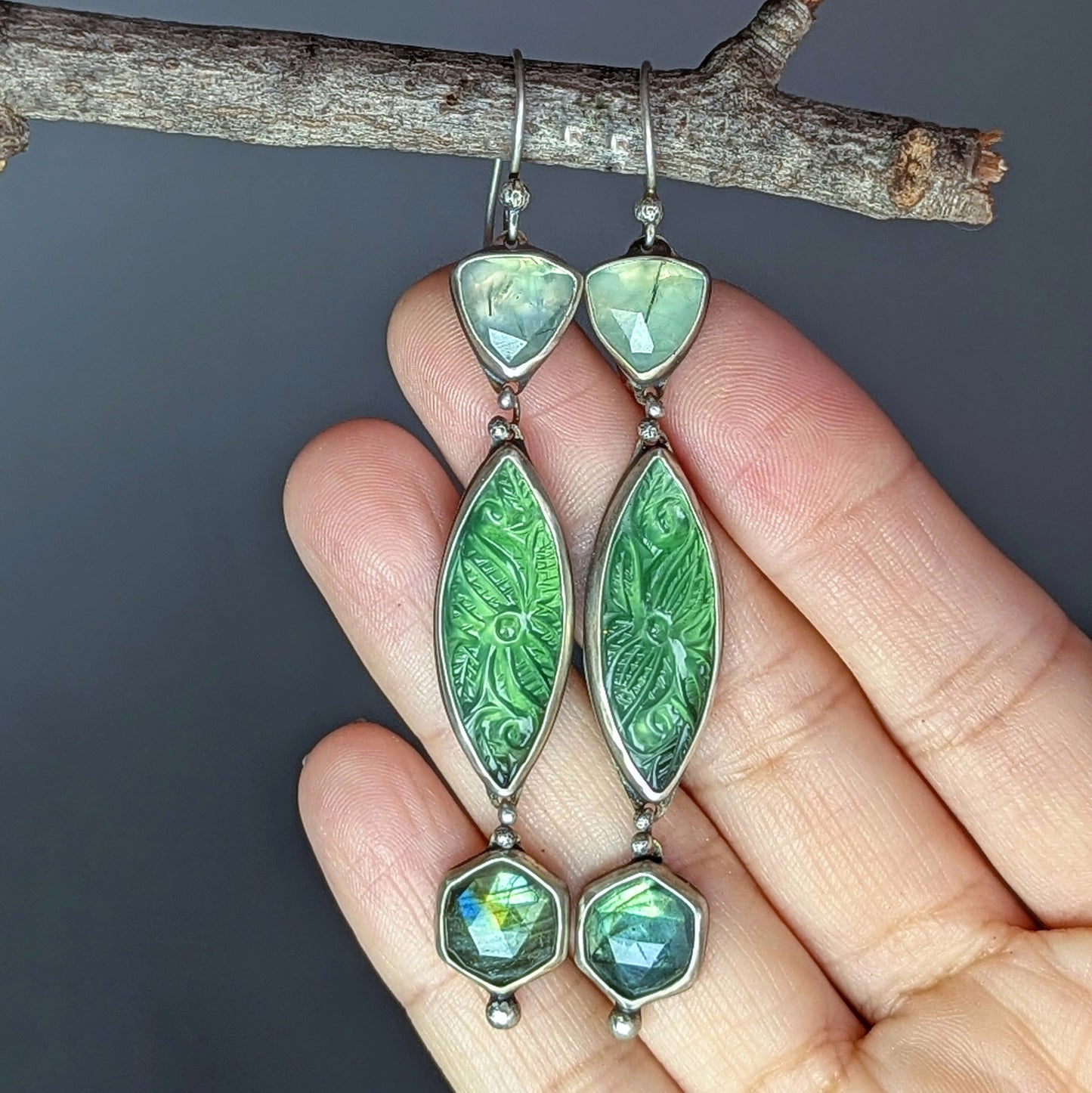 Carved serpentine, labradorite, and prehnite artisan statement earrings.